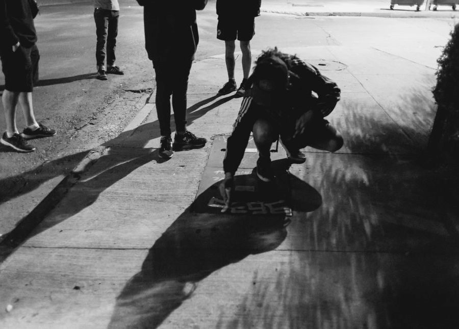 a man is tagging a metal plate