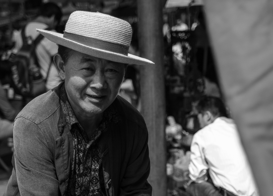Peking; a old man wearing a hat