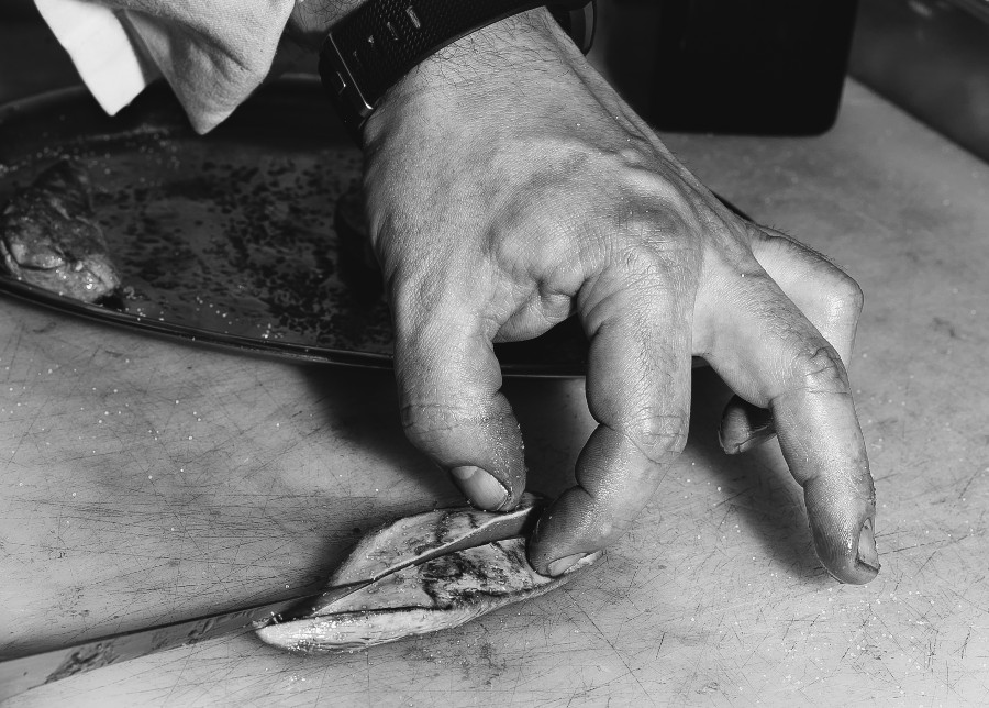 a chef is cutting a piece of meat