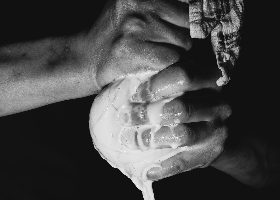 A chef is wringing something in a towel